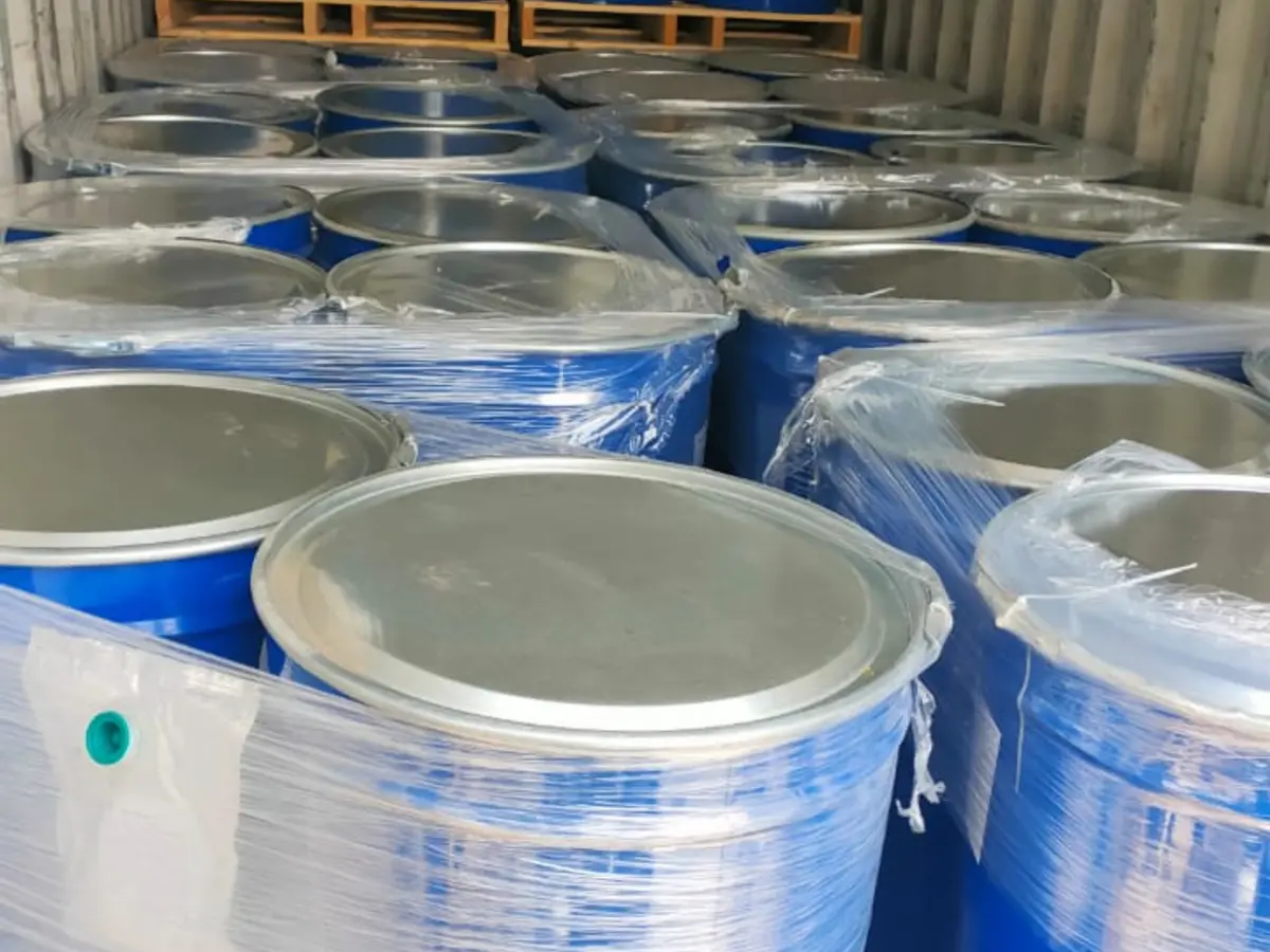 Blue industrial drums wrapped and staged inside a shipping container